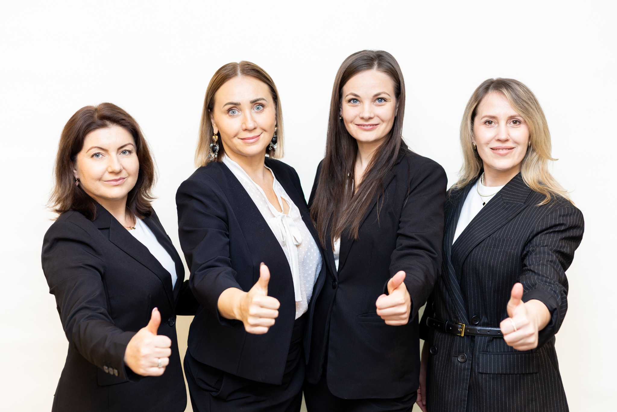 Professional women giving thumbs up