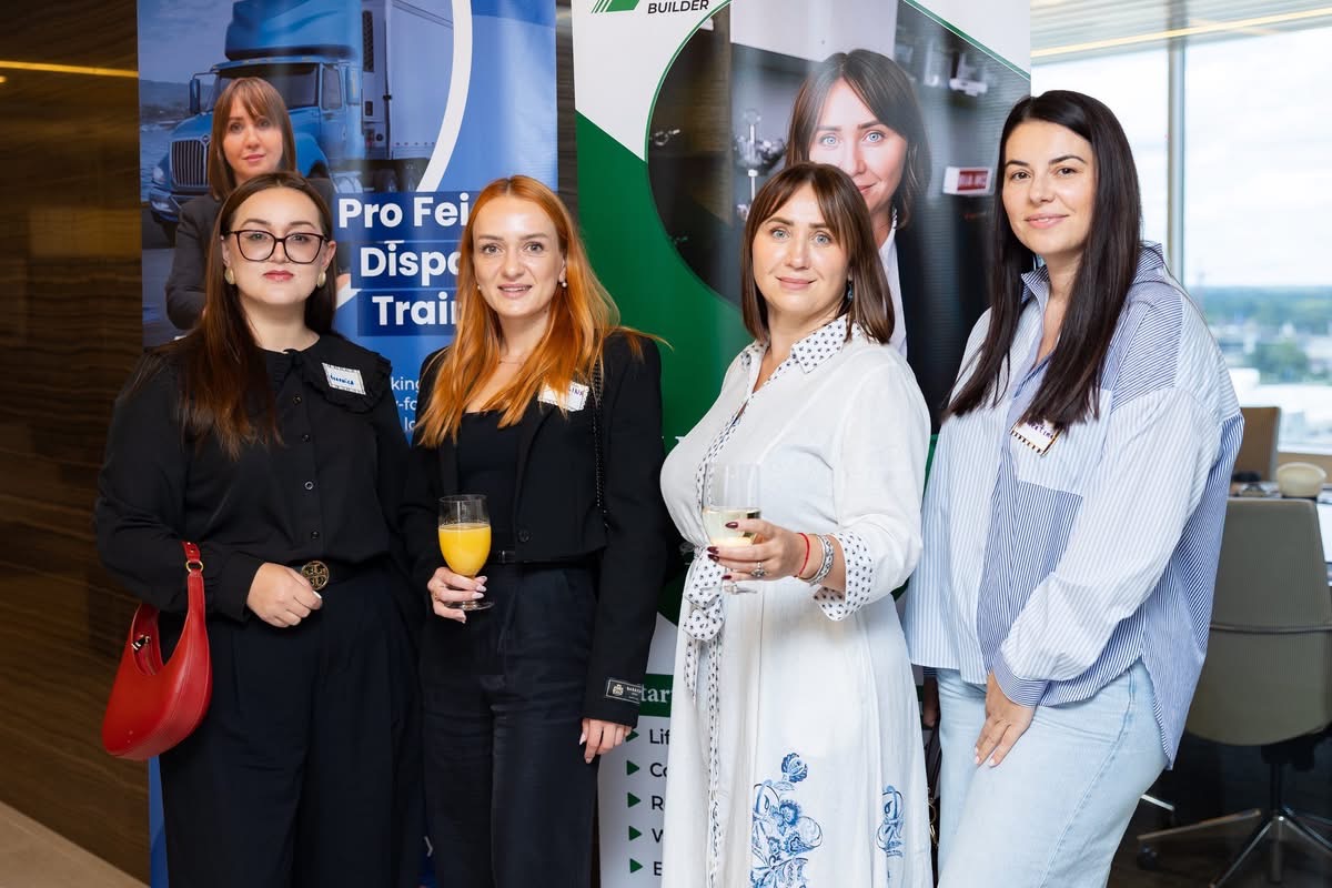 Women near sponsor banners