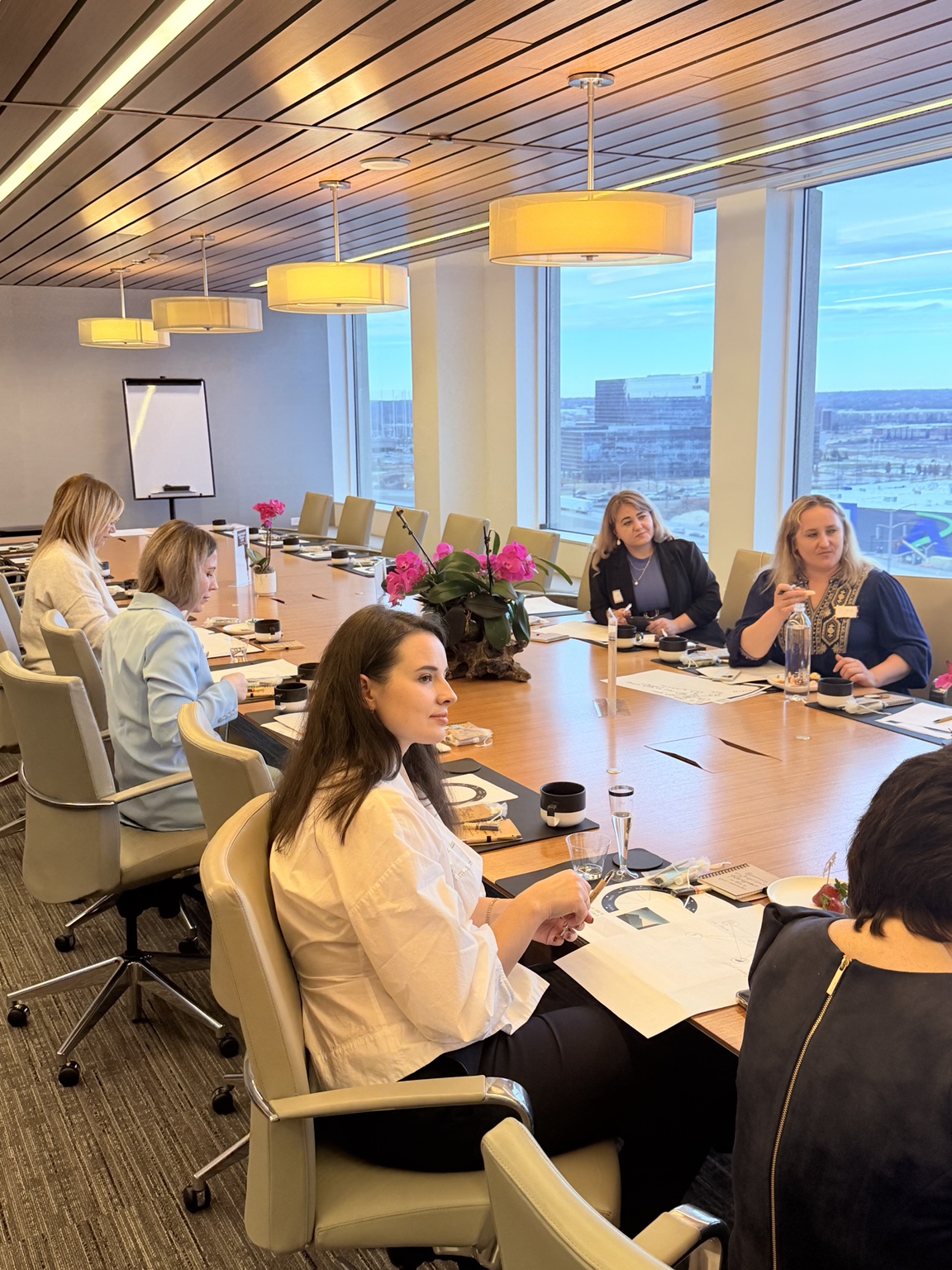 Women in business balance event around conference table