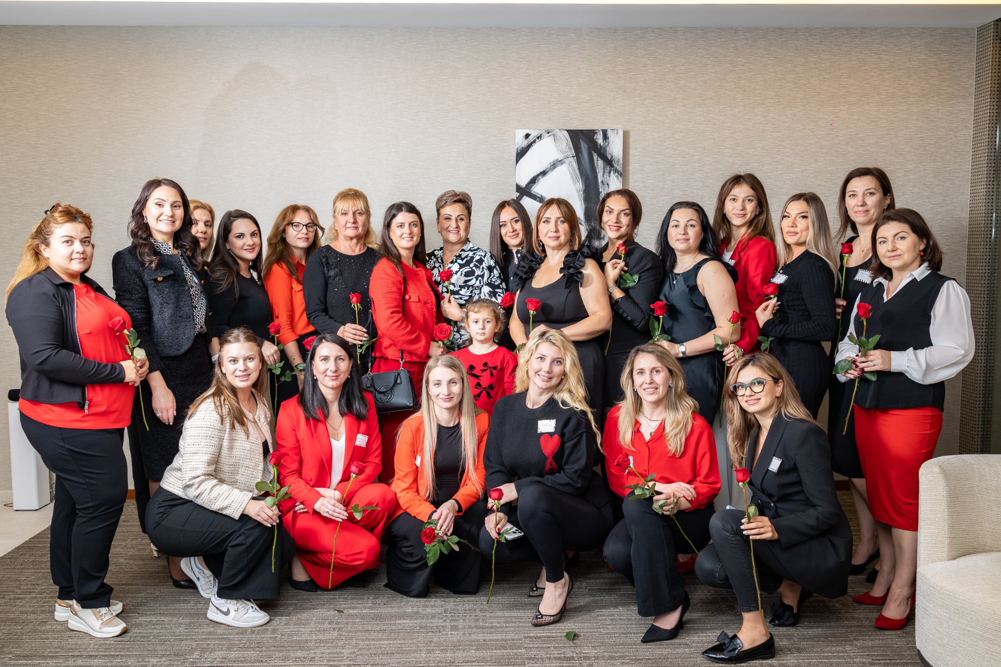 Red and black networking event group holding roses